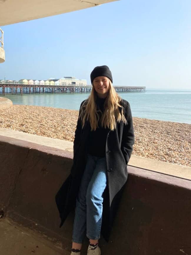 Sat on the seafront wall by the pier