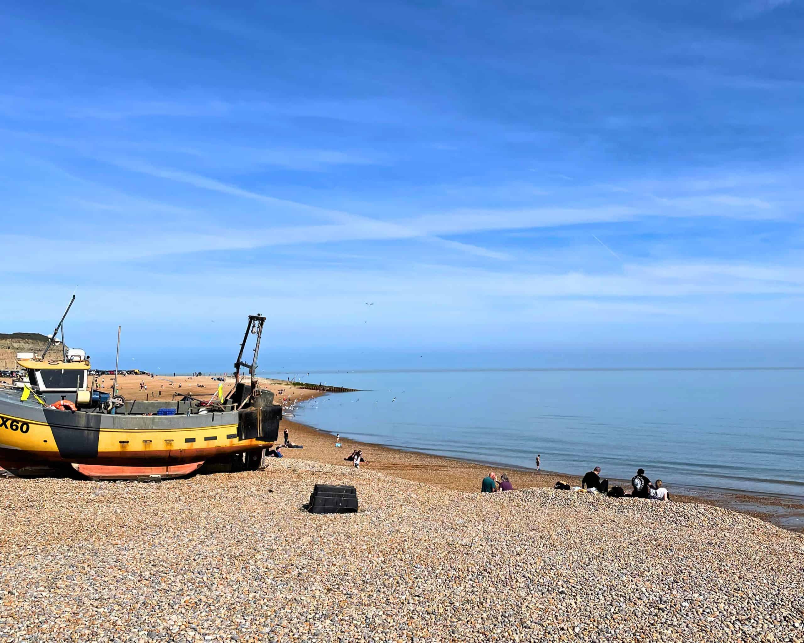 Is Hastings worth visiting? The picture of fishing boats, pebble beach and bright sunshine and blue skies proves it!