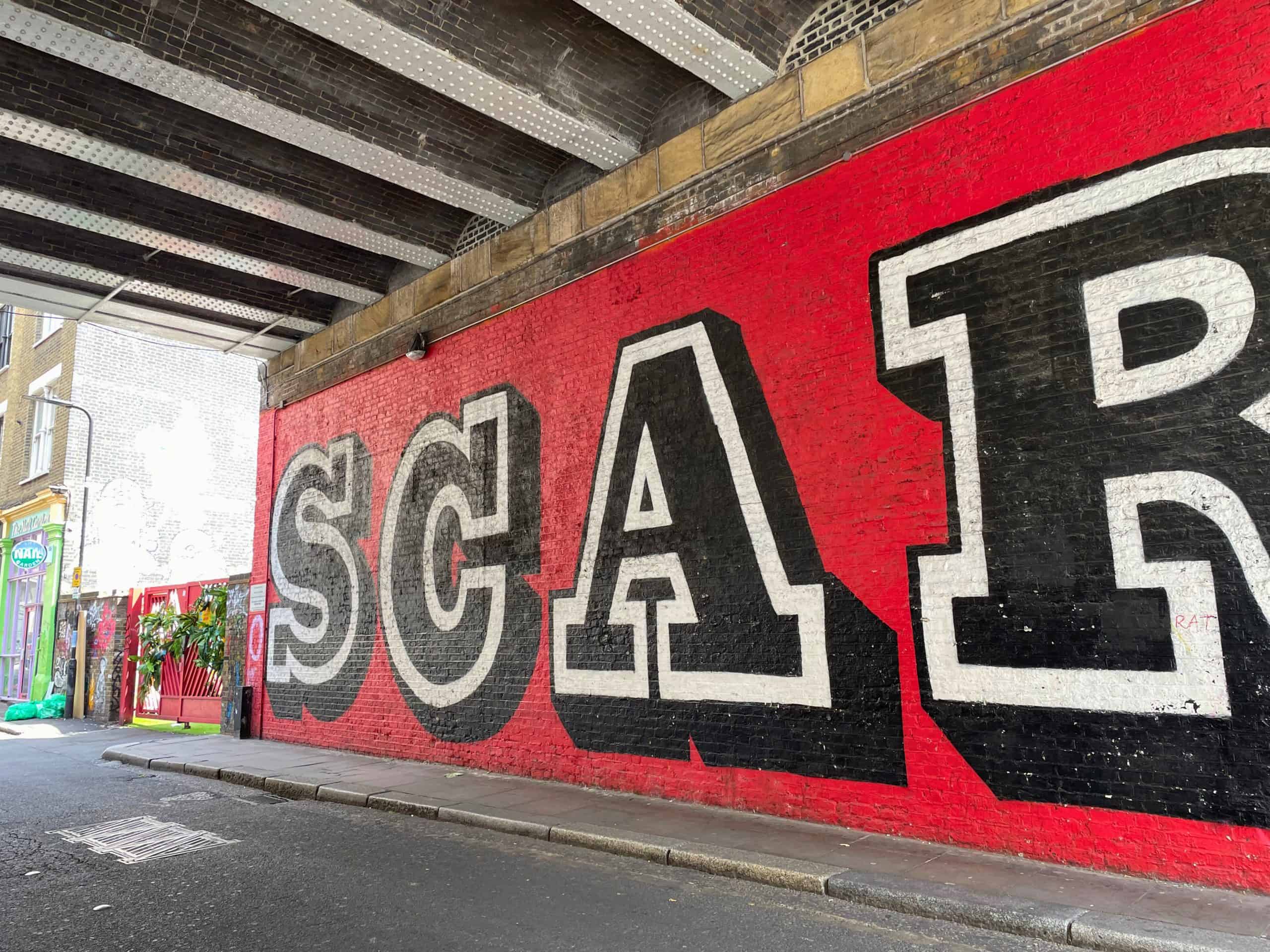 Bright red graffiti under a bridge in Shoreditch