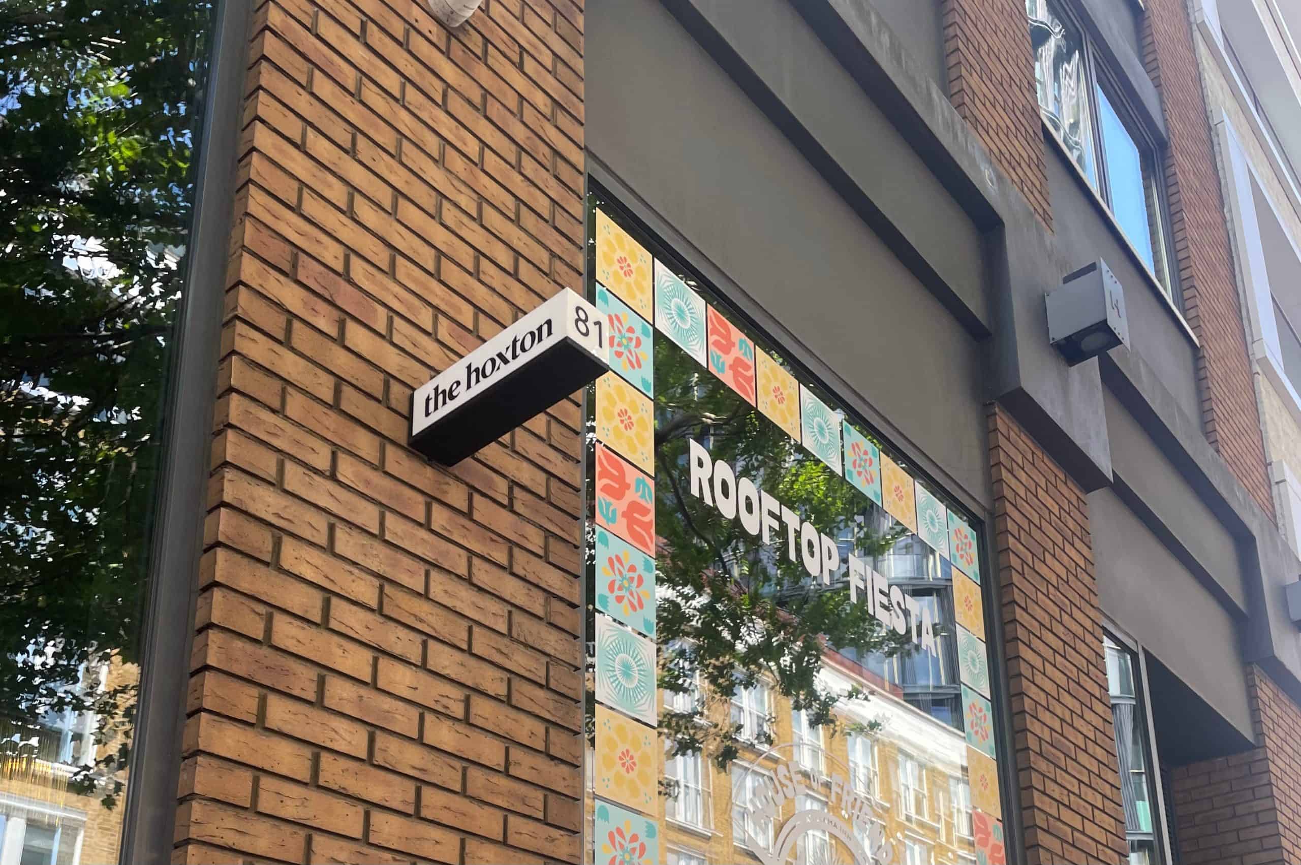 a sign saying 'The Hoxton' outside the hotel in London
