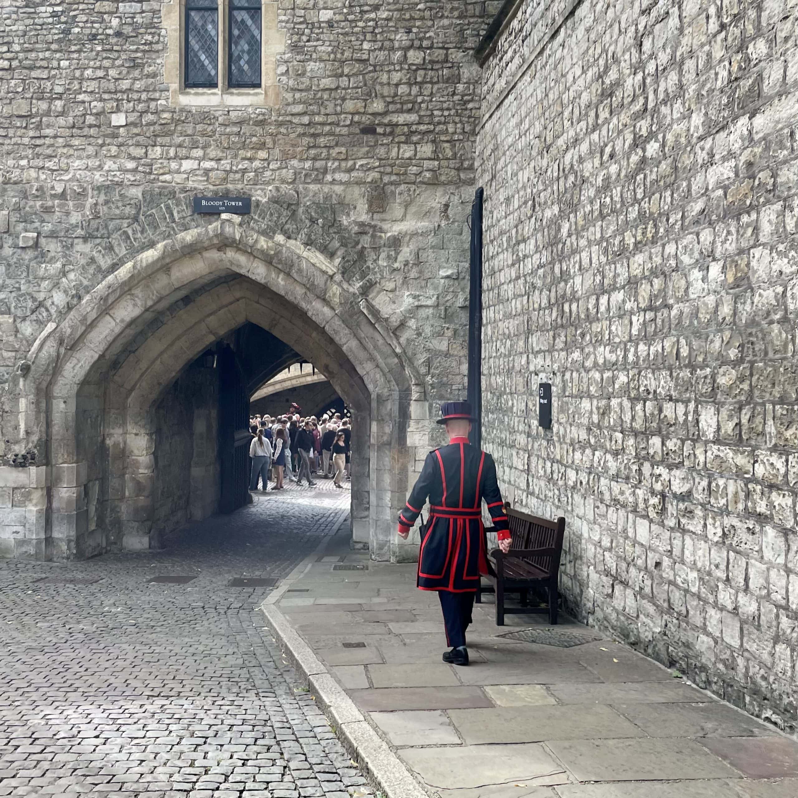 A Yeoman Warder walking through a gate