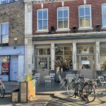 A romantic street in London, lined with cafes and bicycles